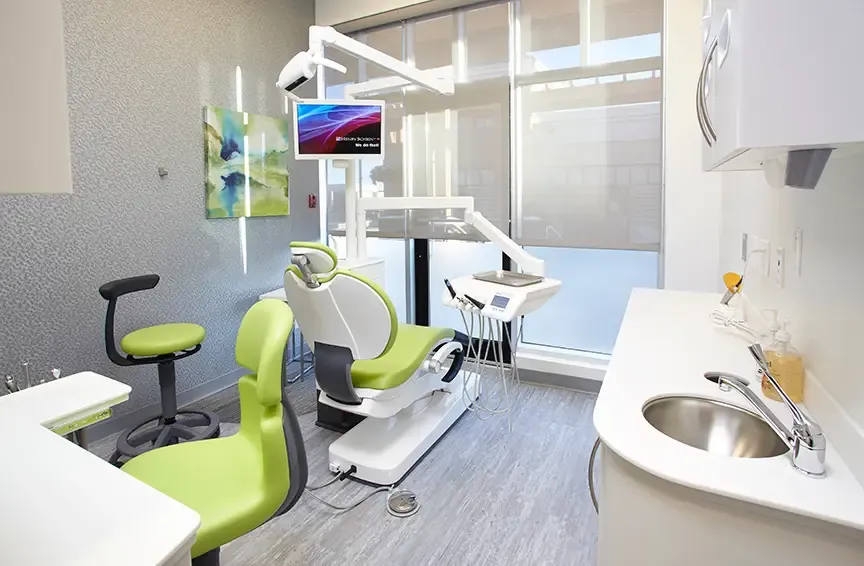 Treatment room with a green dental chair