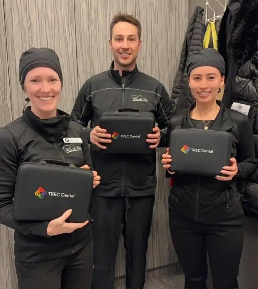 Ryan, Mindy and Alyse holding TREC Dental cases